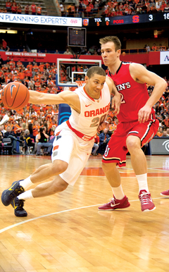 Syracuse shooting guard drives around St. John's swingman Marco Bourgault.