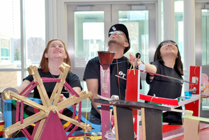 Past NASA Maker Faire participants try out one of the many activities available.