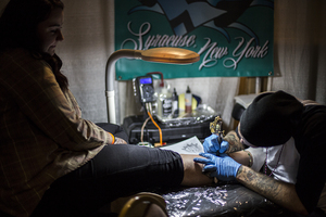 An Am-Jam Expo attendee receives a new tattoo from one of the many artists at the event