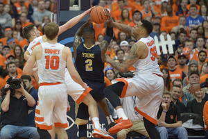 Tyler Lydon, Trevor Cooney and Dajuan Coleman surround Pittsburgh's Michael Young while going for a rebound.