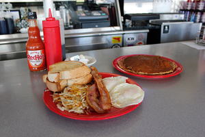 The interior walls of the Gem Diner are covered with classic 20th century memorabilia, including guitars, images of Frank Sinatra and PepsiCola ads.