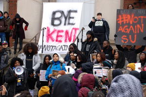 #NotAgainSU relocated to the steps of Hendricks Chapel, where they had strung a large sign between two pillars that read “Bye Kent” in black and red letters. 