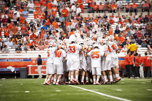 The Syracuse mens lacrosse team celebrates its 15-8 victory over Albany on Saturday. With the win, SU reached a program milestone 800th victory in its history.