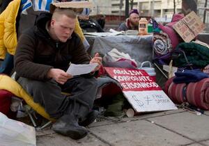 Jeremy Bailey,  a member of Occupy Syracuse, looks over the list of resolutions given to protestors by Mayor Stephanie Miner. We live here, were the people who pay taxes for these roads, he said.