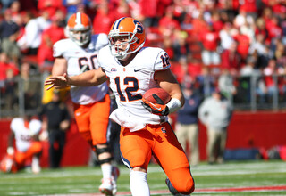 Syracuse quarterback Ryan Nassib scrambles, looking for a running lane.