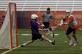 Syracuse attack Dylan Donahue fires a shot into the back of the net for one of Syracuse's 16 goals against Holy Cross.