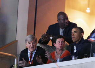 (From left to right) Dr. Mark A. Emmert, President of the NCAA, and Chancellor Nancy Cantor of Syracuse University speak with President of the United States Barack Obama in a sky box.