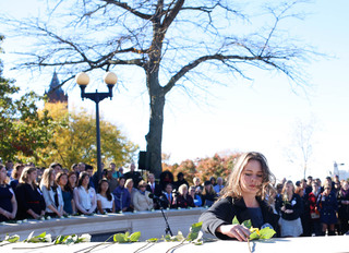 Lockerbie Scholar Megan Noble, lays a rose in memory of Andrew McClume, a victim of the Pan Am 103 terrorist attack.