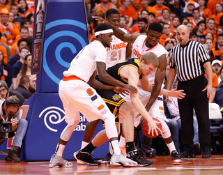 Johnson and SU center Chinonso Obokoh converge on the ball in the paint.