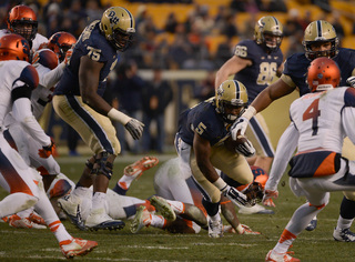 Running back Chris James looks upfield as he carries the ball.