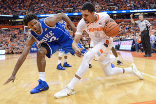 Syracuse forward Michael Gbinije crosses the ball over against Winslow to keep possession.