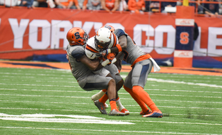 Two Syracuse defenders take down a Virginia Tech player. The Orange allowed 468 yards of total offense, but VT scored only three times. 