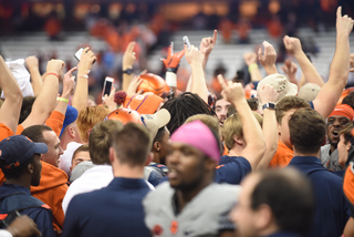 Students who rush the field mingle with players after the big win. 