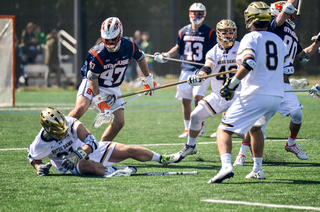 Syracuse's Joe Gillis stands over a UND defender. 