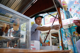 Employee of Josephine’s Glazed Donuts Marcuss Harp hands out free samples of their namesake.