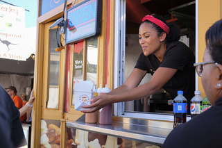 Lisa Greene serves customers her poutine from Gourmet Poutine.