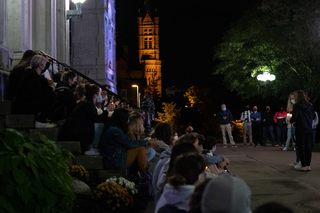 The student attendees sit and listen to survivor's tell their stories.