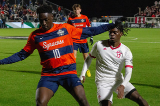 Nathan Opoku weaves his path through the defenders to make his way down the field to the goal. Opoku was the first to score a goal for the Orange in the 23rd minute of the game. 